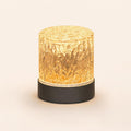 Emberglow round frosted glass lamp glowing warm amber on cream background